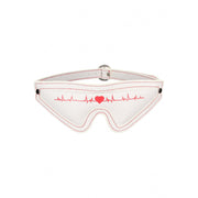 White eye mask with red stitching and a red heartbeat graphic.