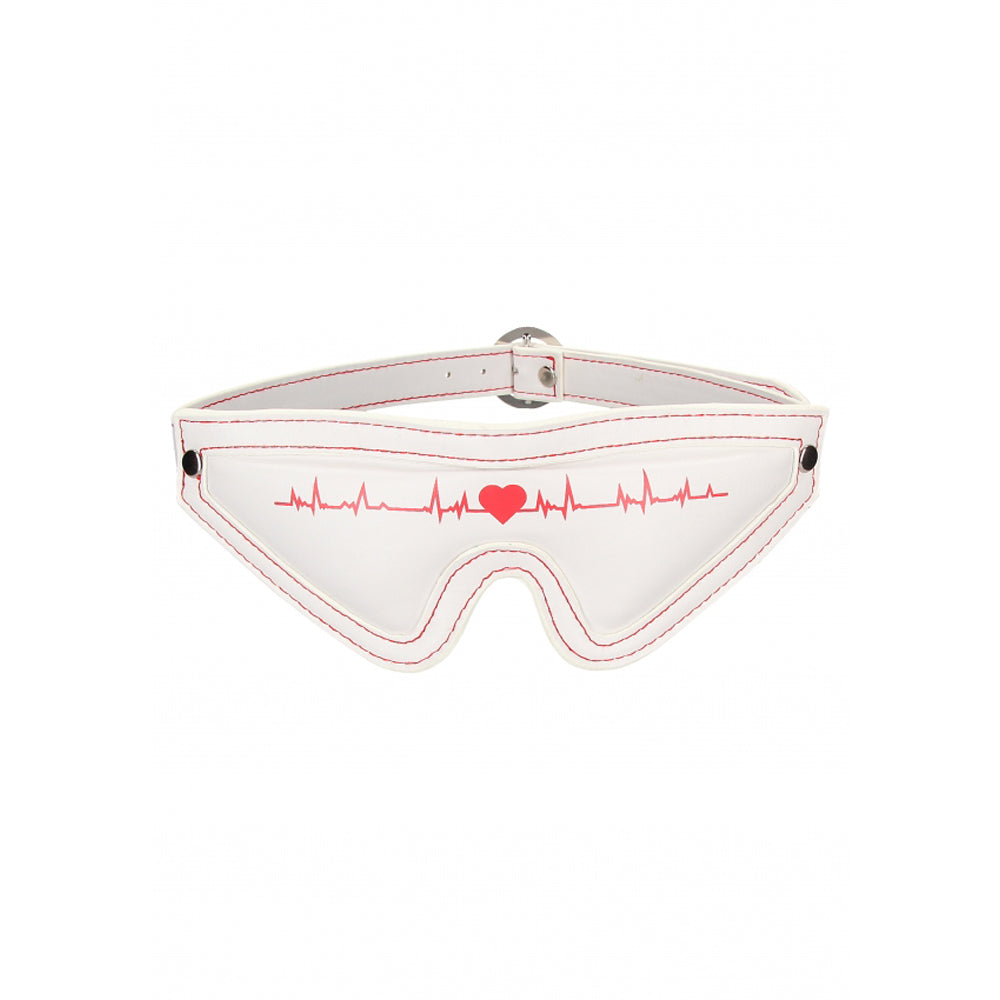 White eye mask with red stitching and a red heartbeat graphic.