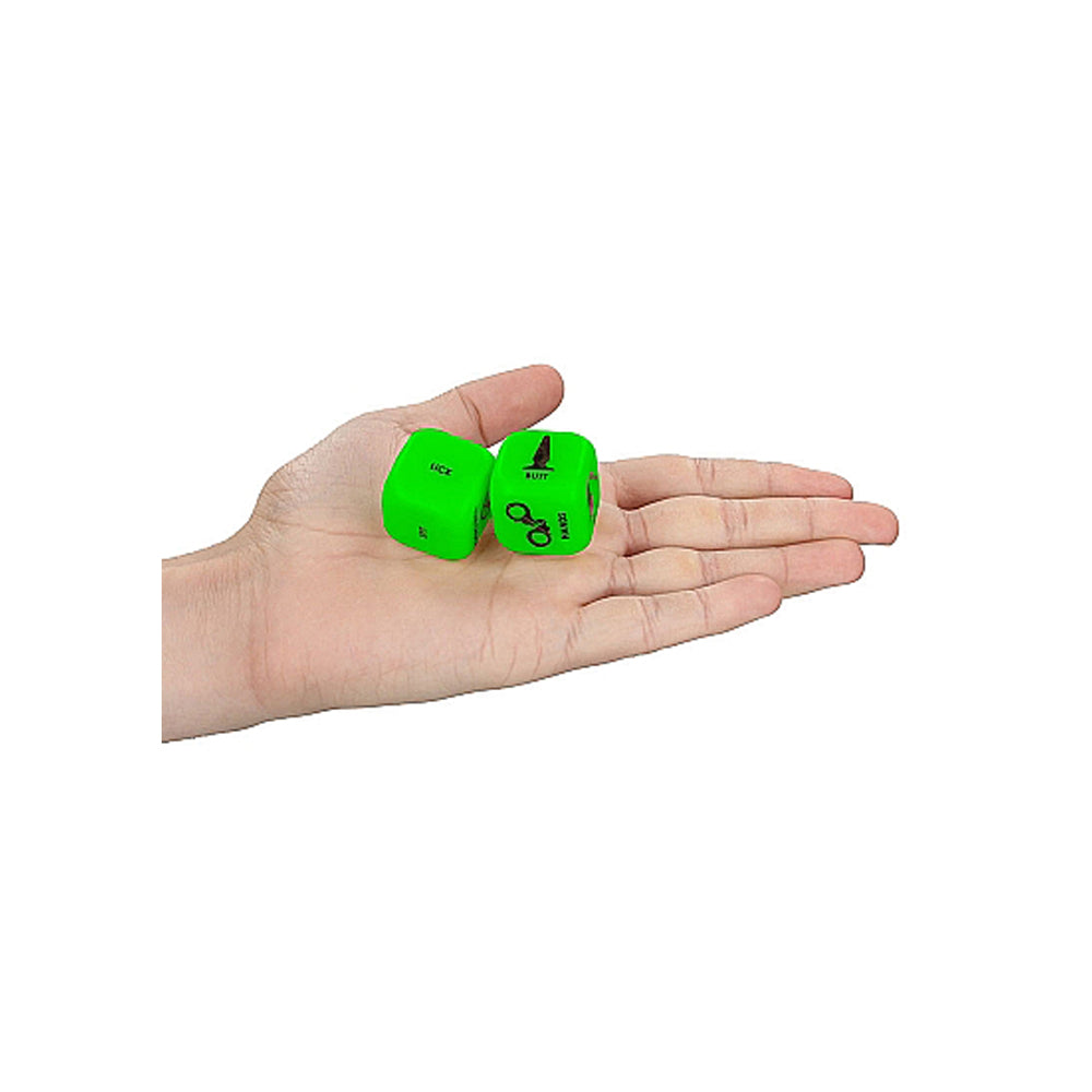 Two green dice with symbols for luck, suit, and scissors on a hand.