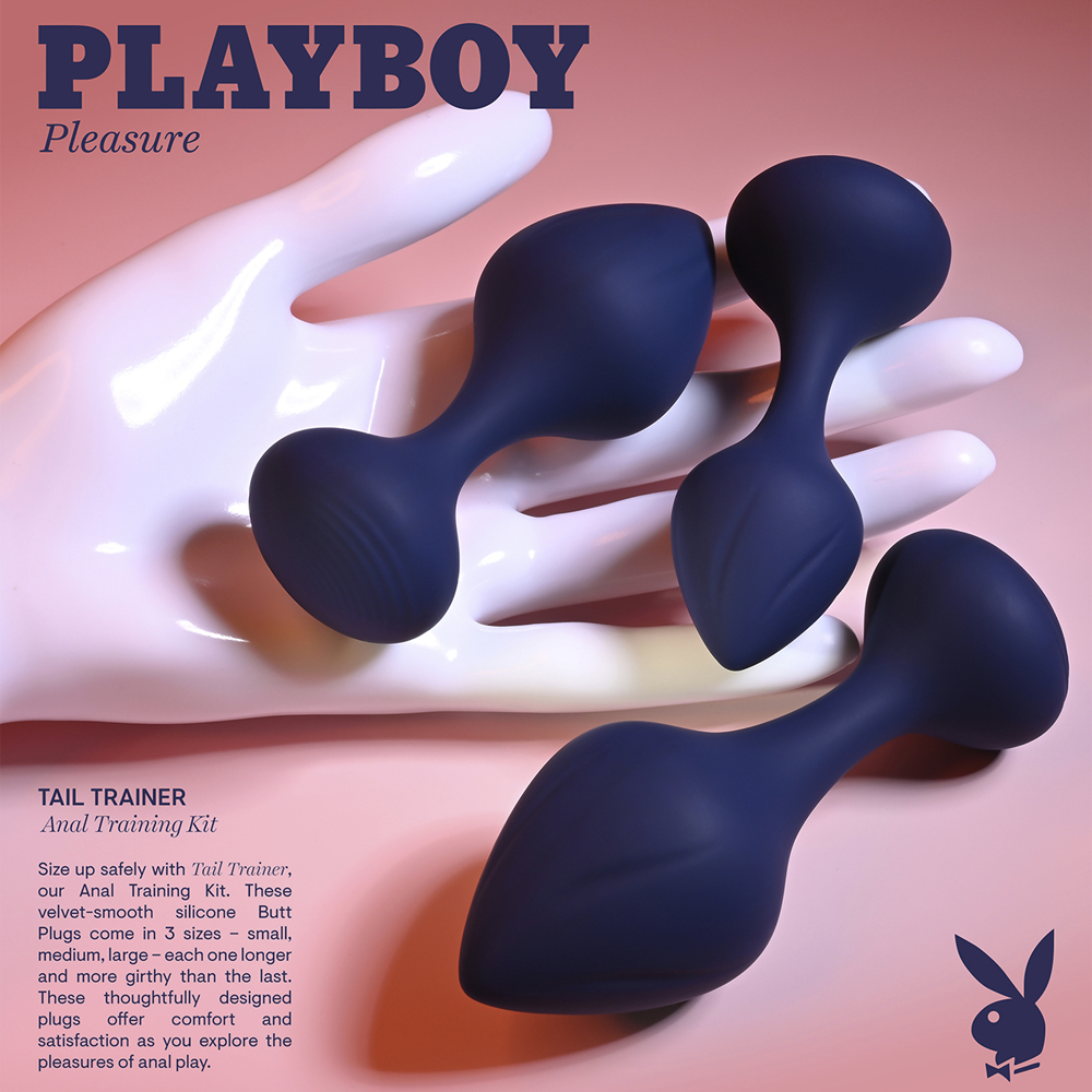 Three navy blue silicone butt plugs of varying sizes rest on a white hand.