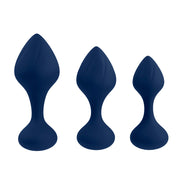 Three navy blue silicone butt plugs of graduated sizes.