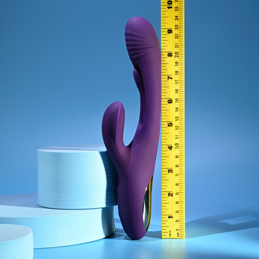 A purple rabbit vibrator is shown next to a ruler measuring approximately 9.5 inches.