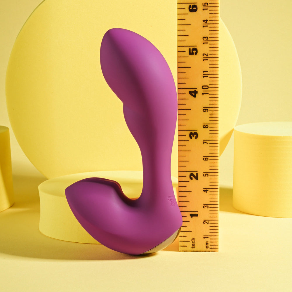 Purple rabbit vibrator with a ruler for scale.