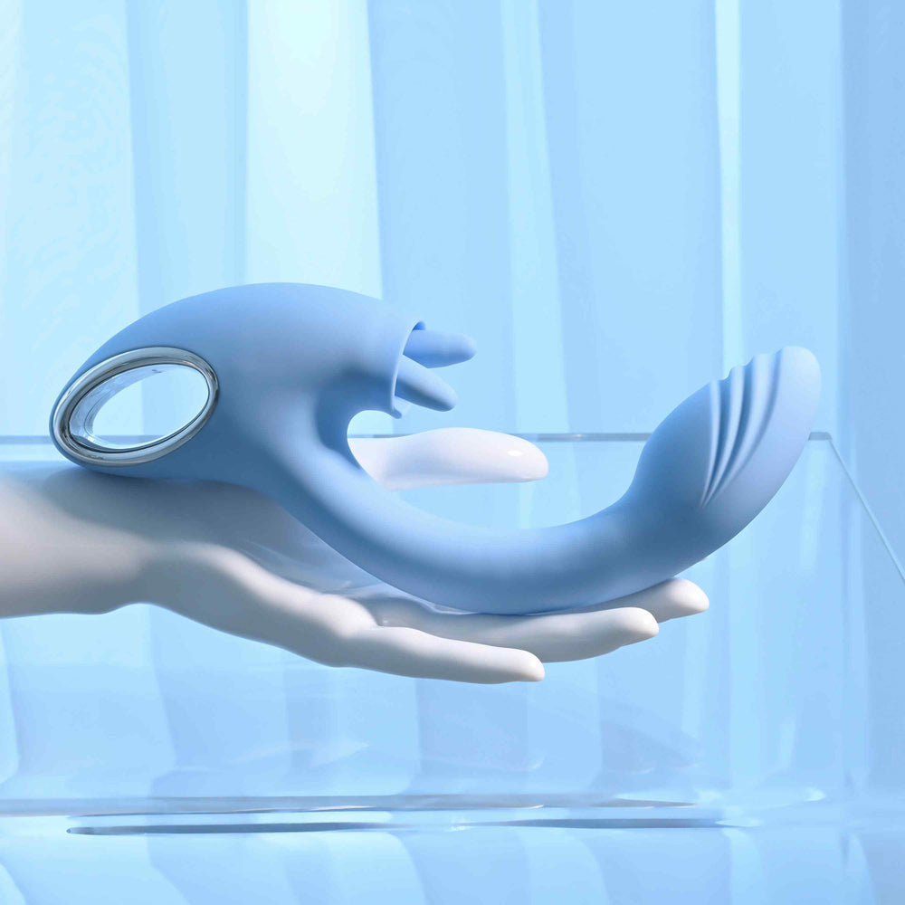 A blue dual G-spot and clitoral vibrator held in a white hand.