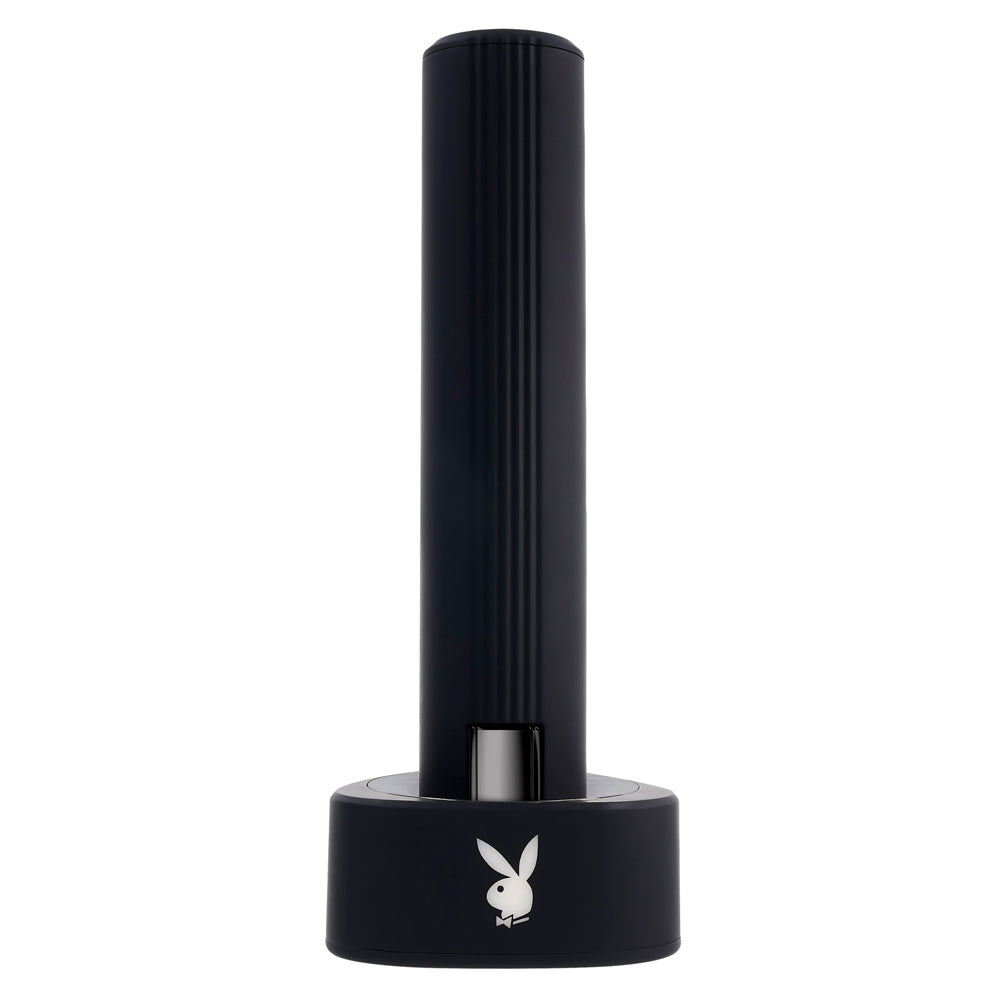Black silicone vibrator with Playboy logo on charging base.