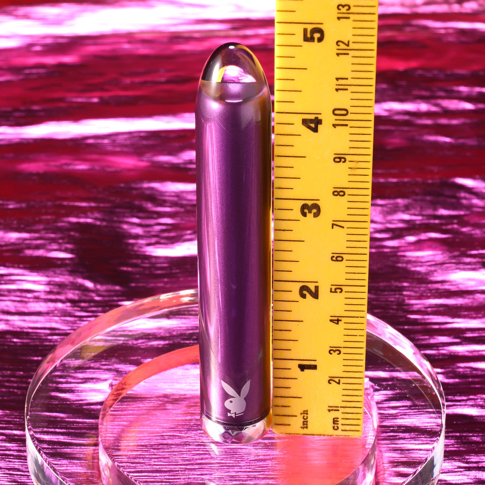 Purple glass vibrator with Playboy logo, measured against a ruler.
