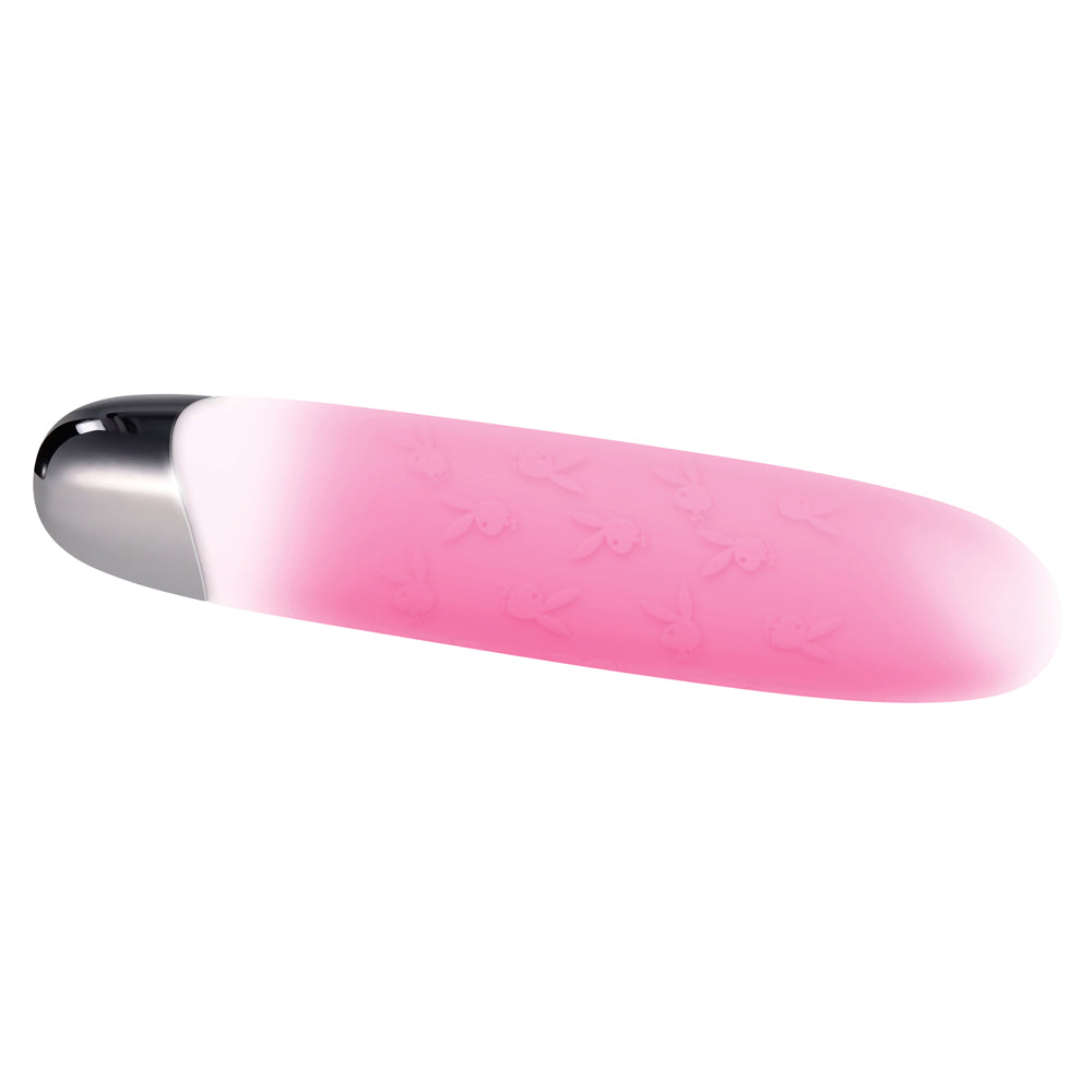 Pink silicone bullet vibrator with Playboy bunny pattern.