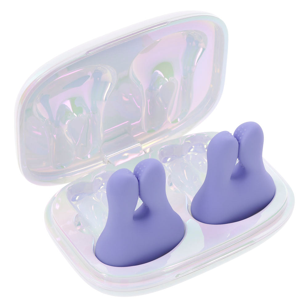 Purple vibrating nipple clamps in a pearlescent charging case.