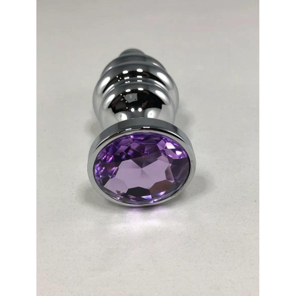 Large stainless steel threaded anal plug with a purple gem.