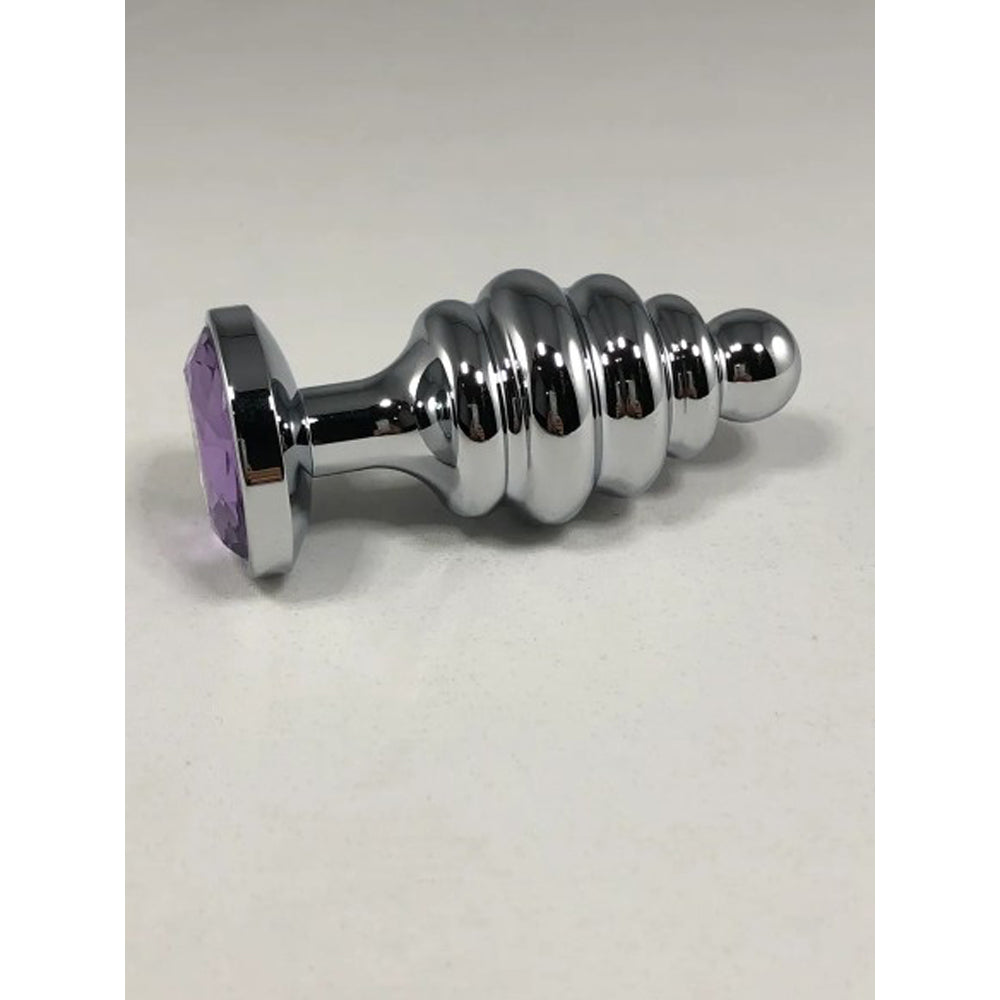Large stainless steel threaded anal plug with a purple gem.