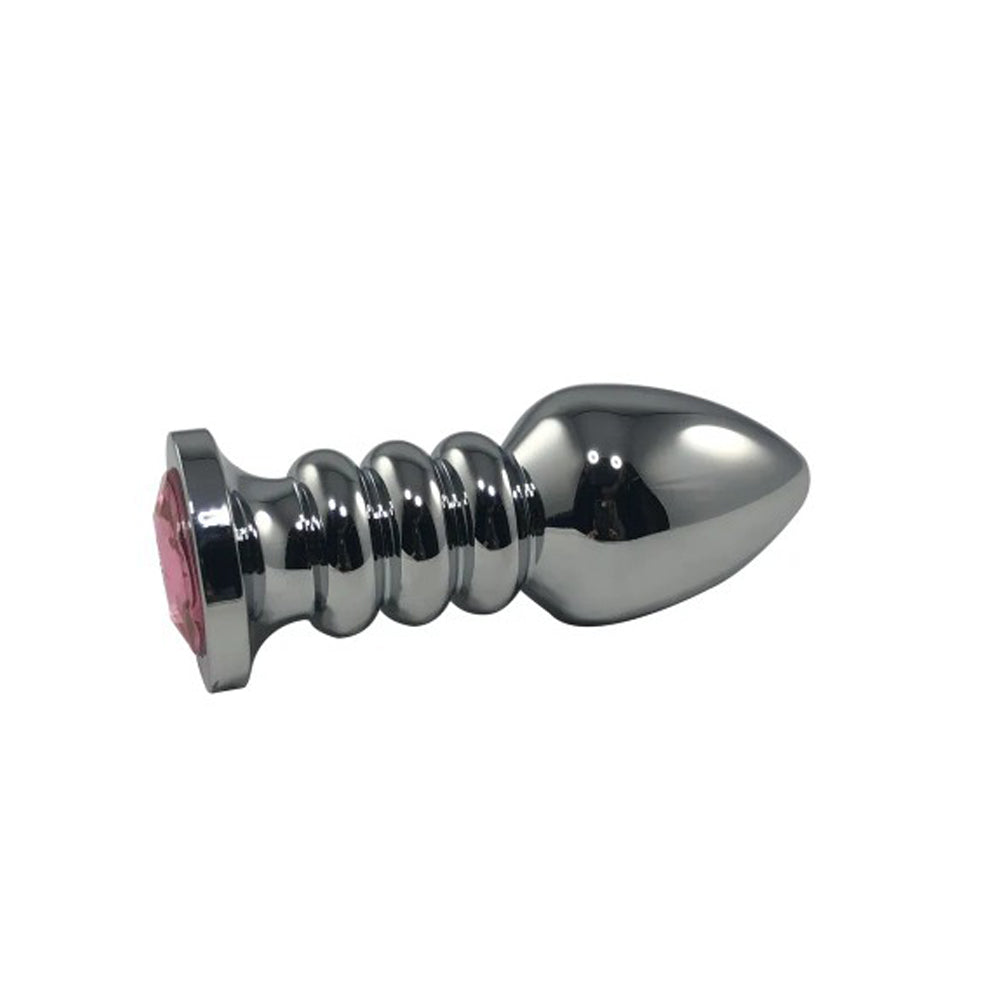 A silver anal plug with a pink gem and ribbed shaft.
