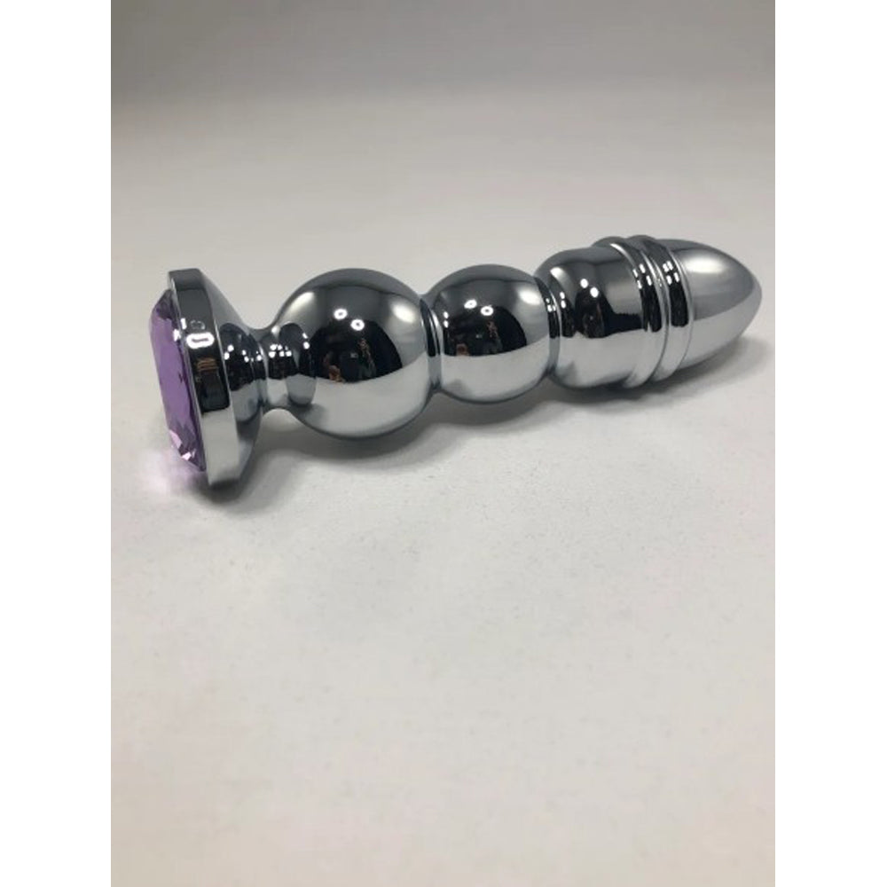 Silver anal plug with a purple gem base.