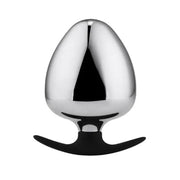 A shiny, egg-shaped stainless steel plug with a black silicone handle.