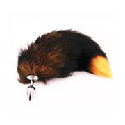 Small stainless steel anal plug with a fluffy fox tail in black, brown, and orange.