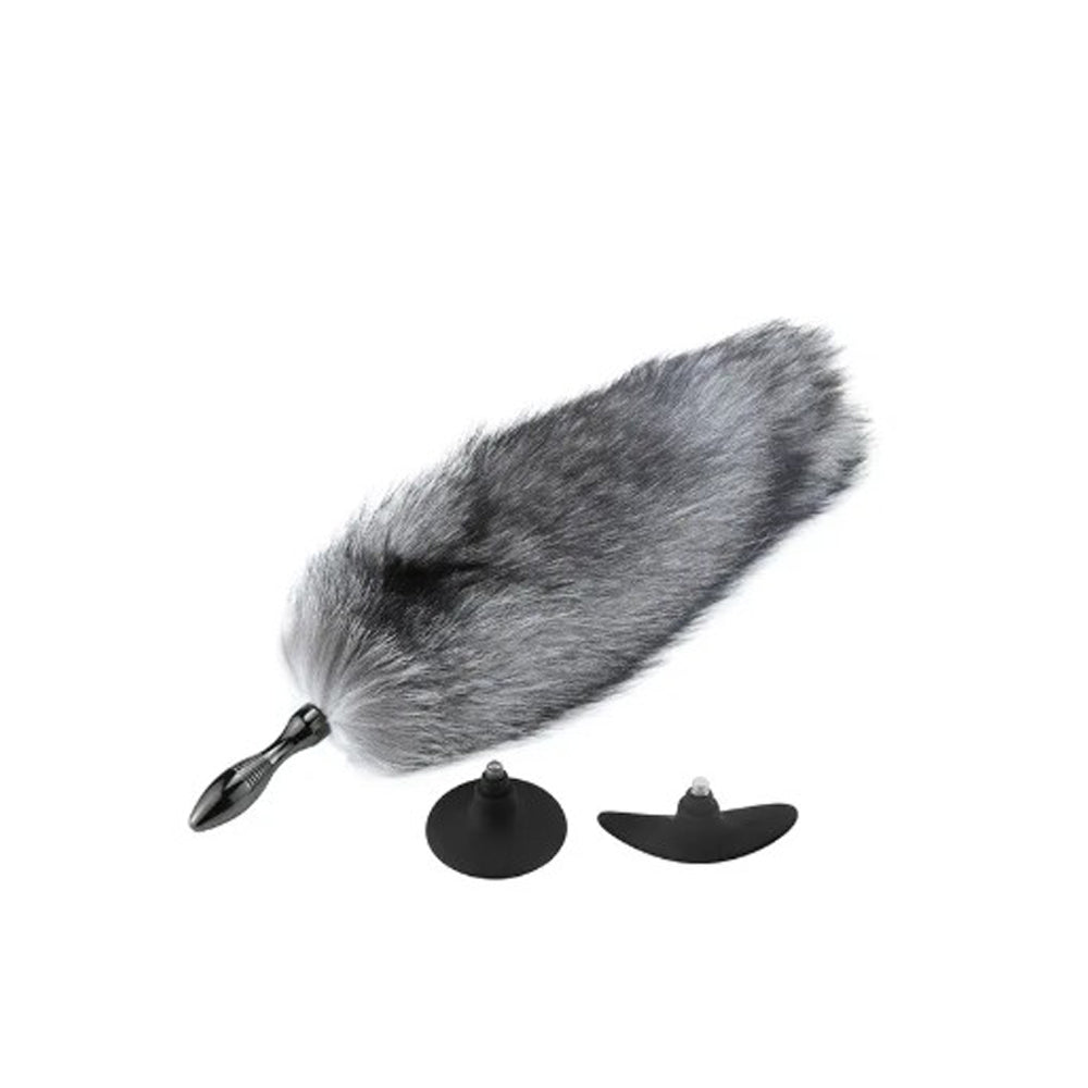 A grey fox tail anal plug with a gunmetal base and two black suction cups.