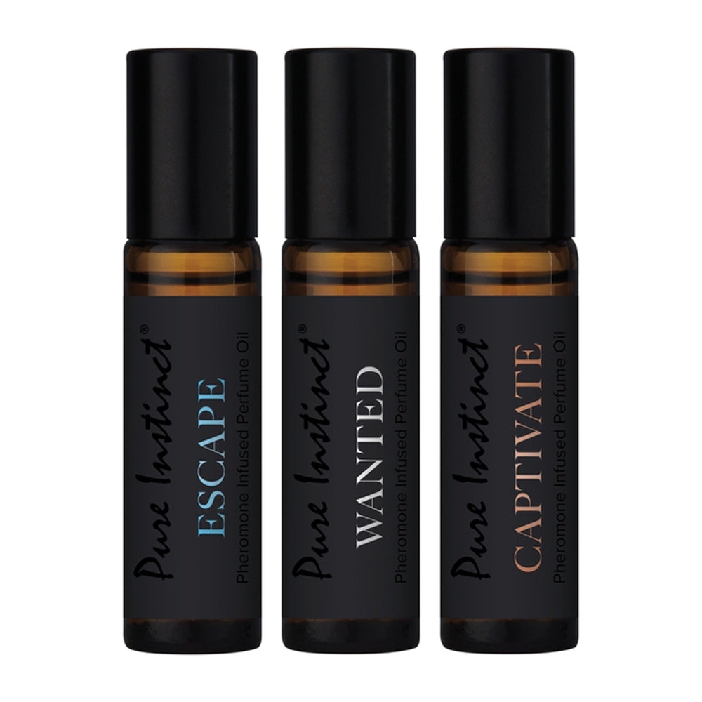 Three Pure Instinct pheromone perfume oil roller bottles: Escape, Wanted, and Captivate.
