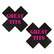 Two black cross-shaped nipple pasties with pink "Great Tits" text.