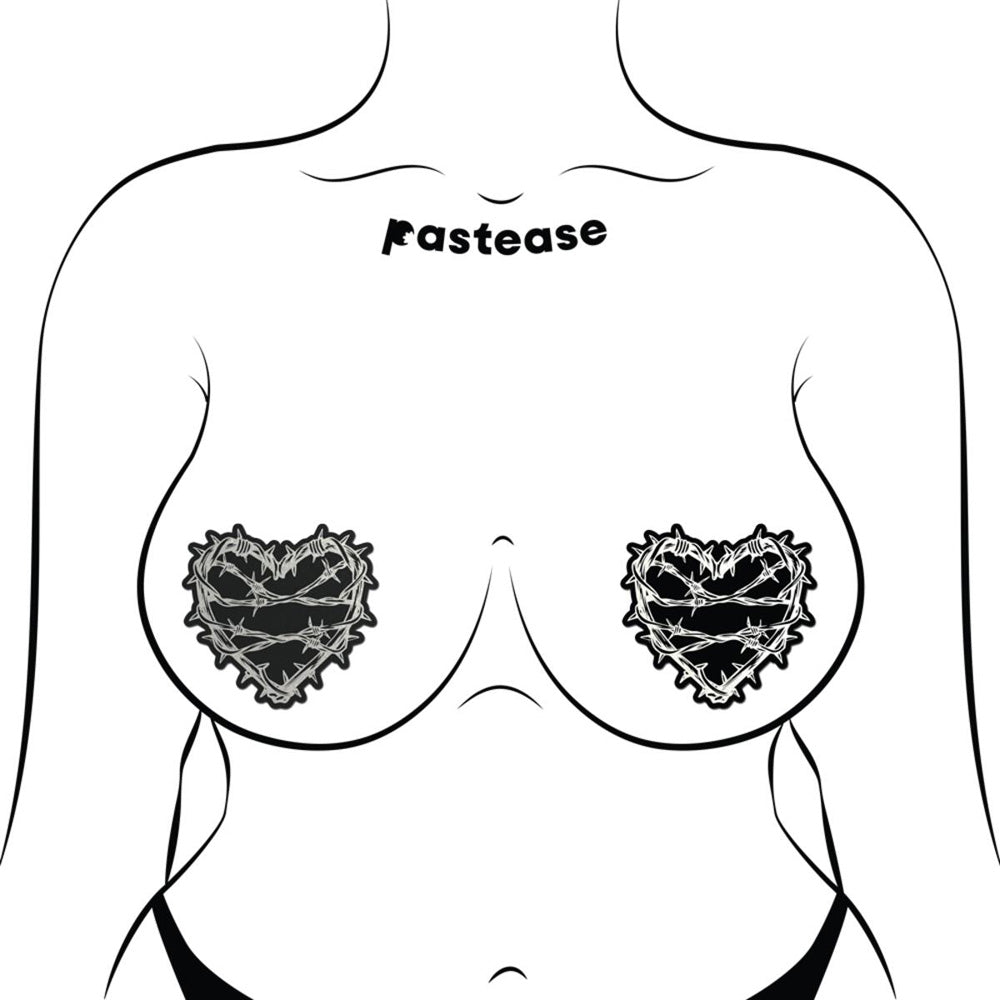 Reflective barbed wire heart nipple covers in black and silver.