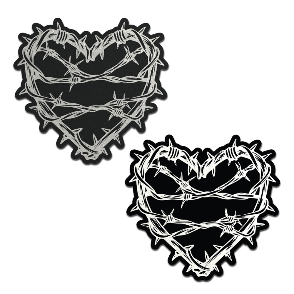 Two black heart-shaped pasties with silver barbed wire designs.