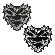 Two black heart-shaped pasties with silver barbed wire designs.