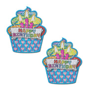 Two glittery cupcake-shaped pasties with "Happy Birthday" text.