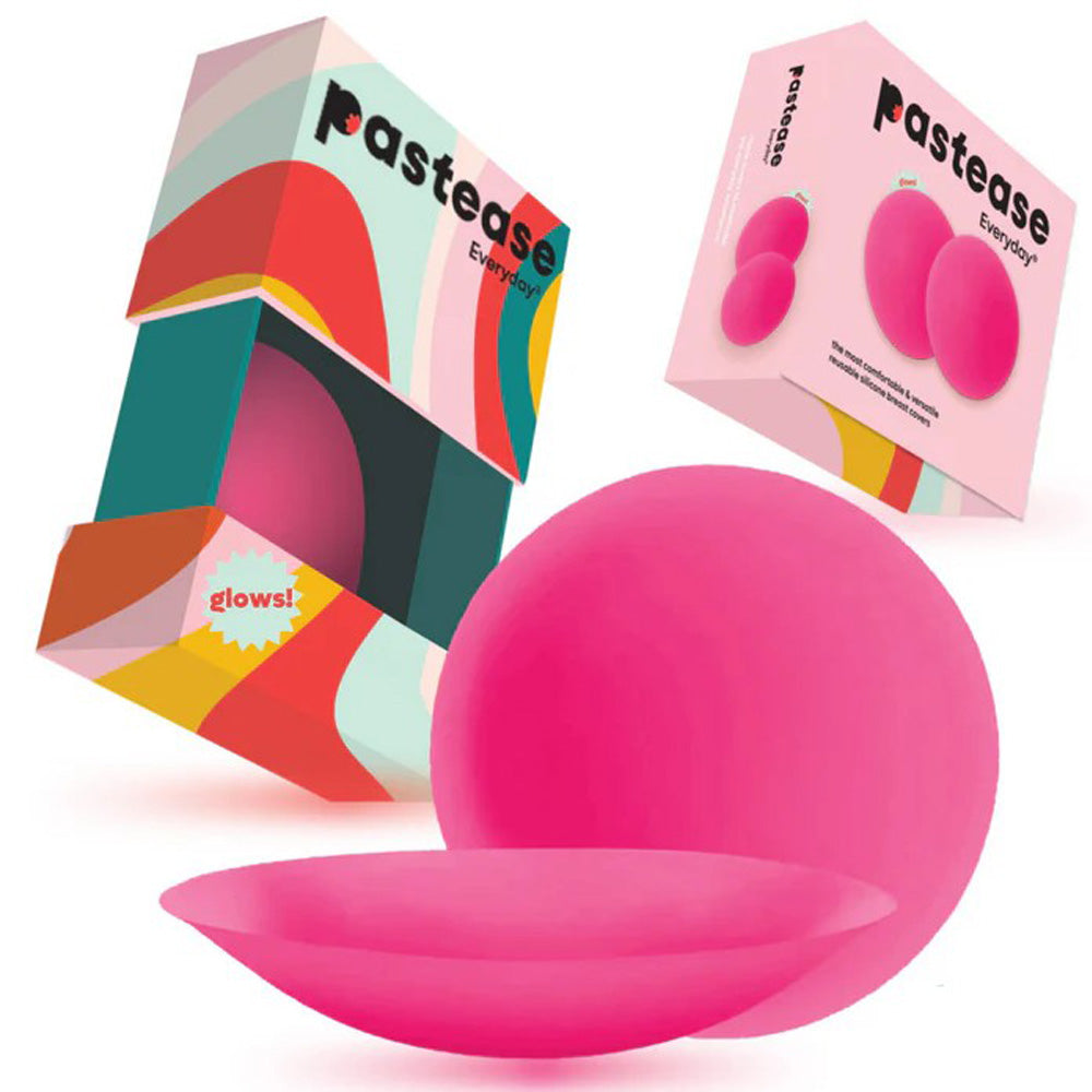 Pink silicone nipple covers with colorful travel boxes.