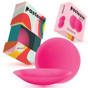 Pink silicone nipple covers with a colorful travel box.