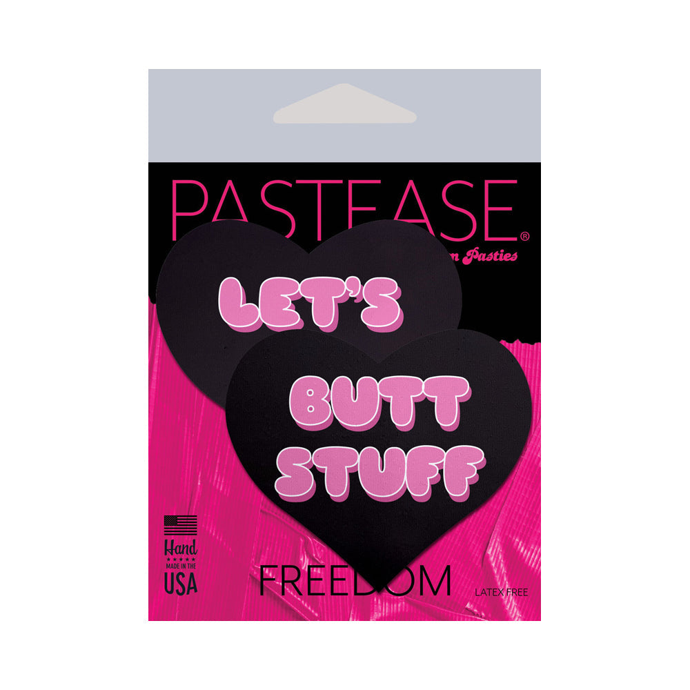 Black heart-shaped pasties with pink text that says "LET'S BUTT STUFF".