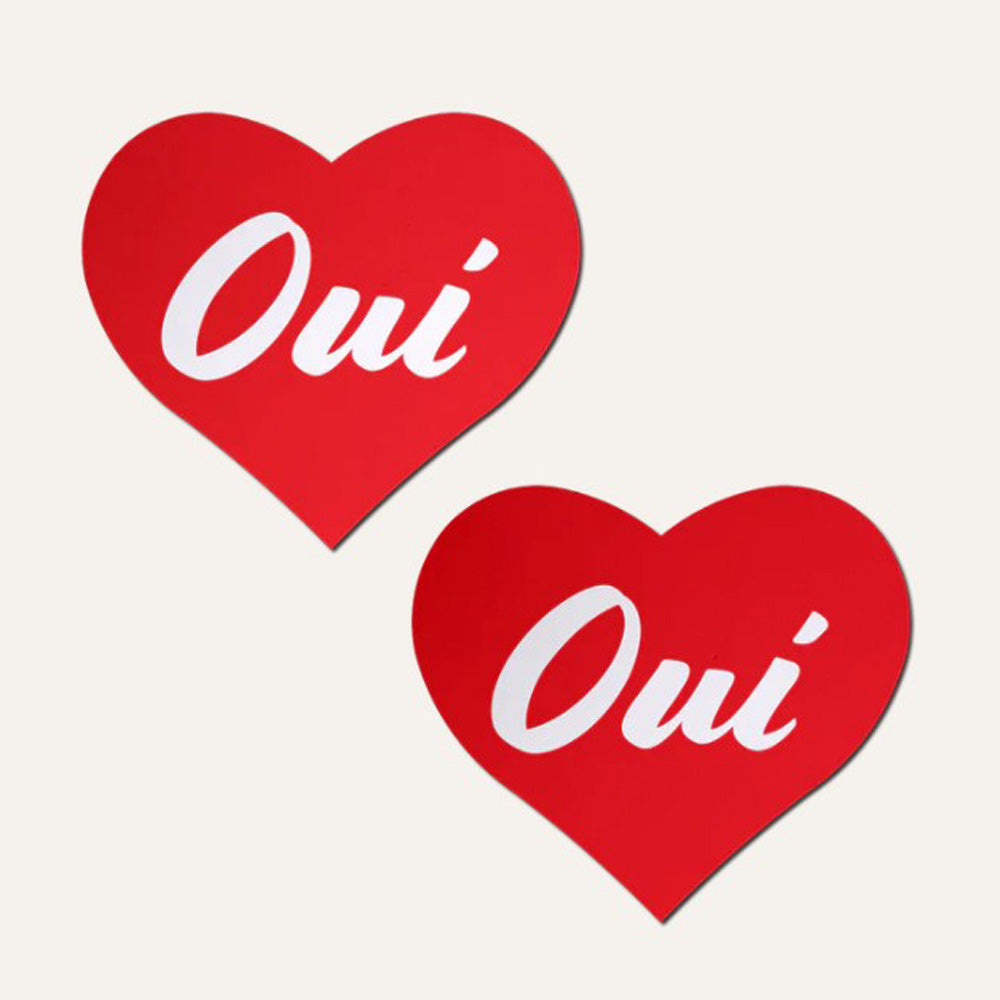 Two red heart-shaped nipple pasties with the word "Oui" in white script.