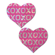 Two pink heart-shaped nipple pasties with an XO pattern.