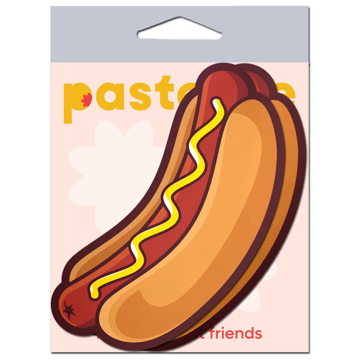 Hotdog shaped nipple pasties with mustard on a pink background.