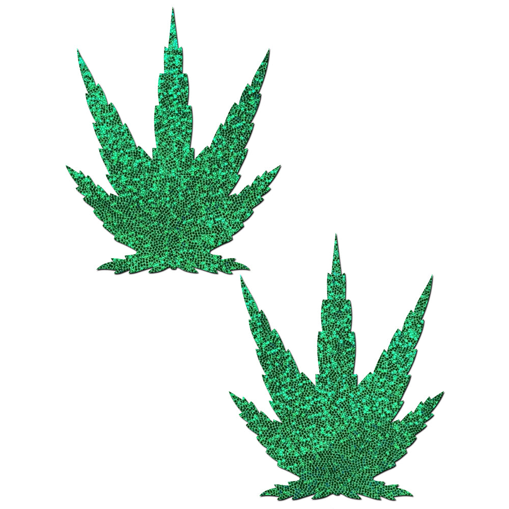 Two green glitter pot leaf nipple pasties on a white background.