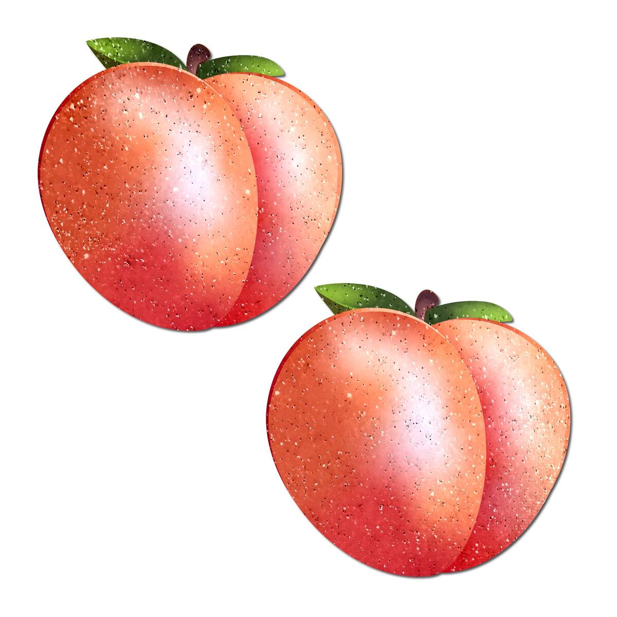 Two sparkling peach-shaped nipple pasties with green leaves.