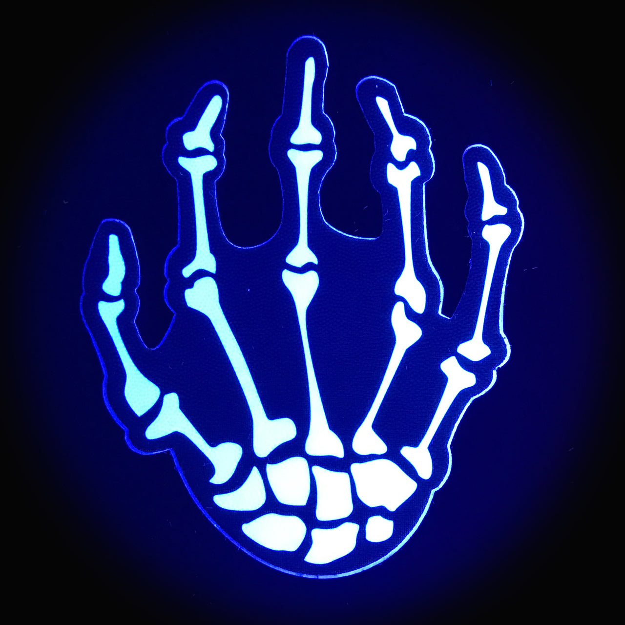 Skeleton hands nipple pasties with white boney design on a blue background.