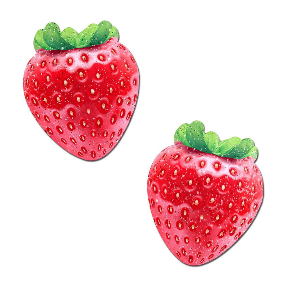 Two red strawberry-shaped nipple pasties with green leaves and glitter.