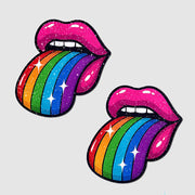 Two sparkly pink lips with rainbow tongues sticking out.