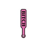 Pink and black enamel lapel pin shaped like a paddle with the word "Bitch".