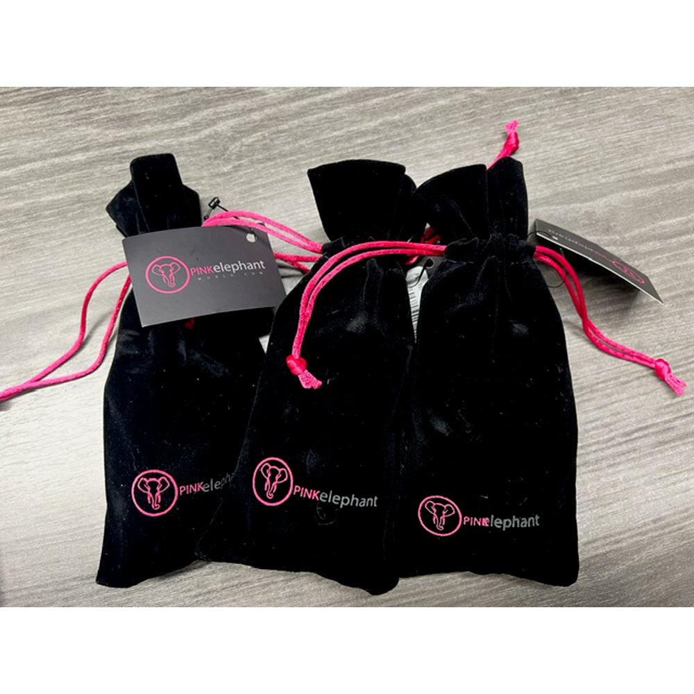 Three black velvet drawstring bags with pink accents and logos.