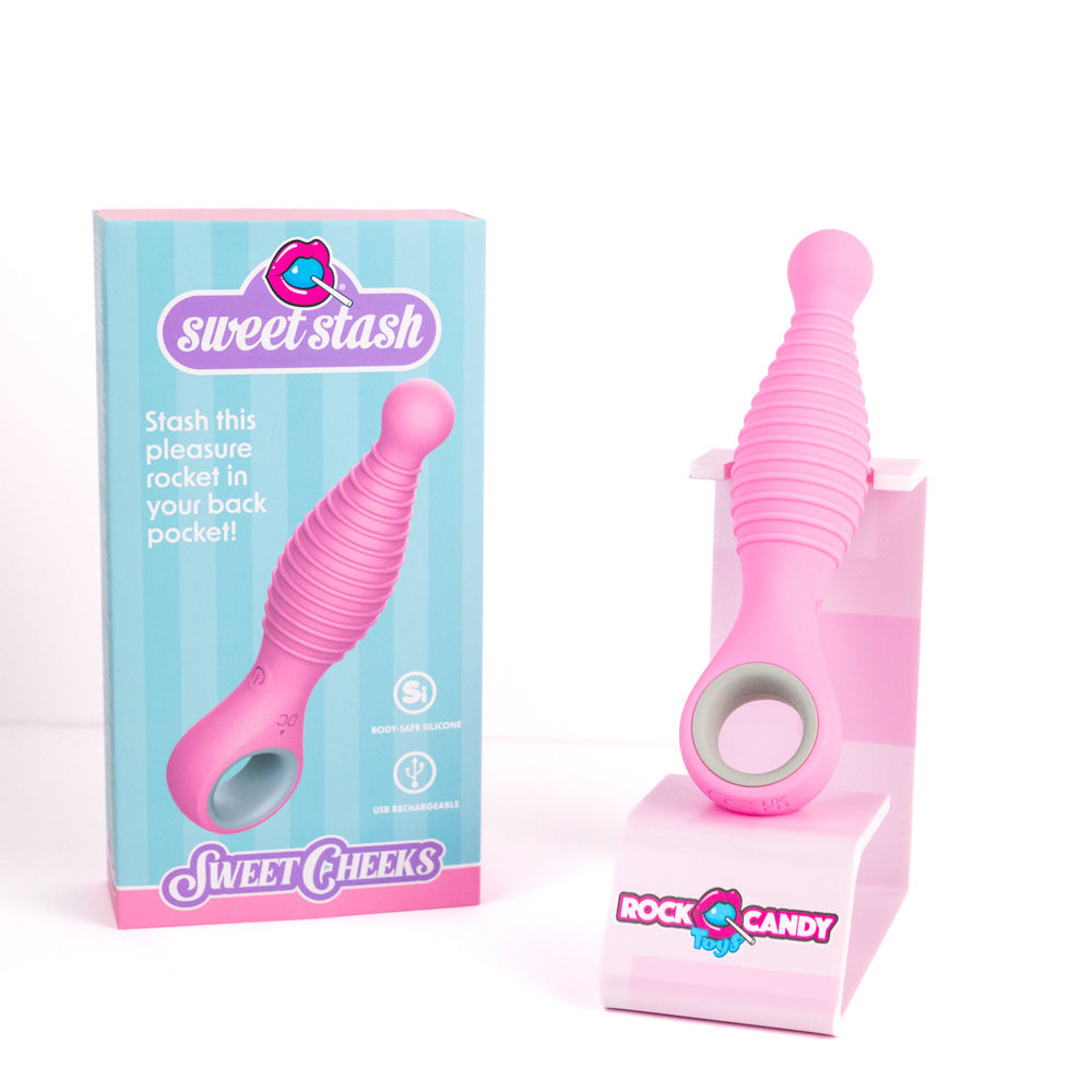 Pink ribbed silicone anal vibrator with a finger loop, next to its box.