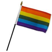 A small rainbow pride flag on a black stick.