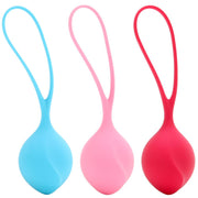 Three silicone Kegel balls in blue, pink, and red with retrieval loops.