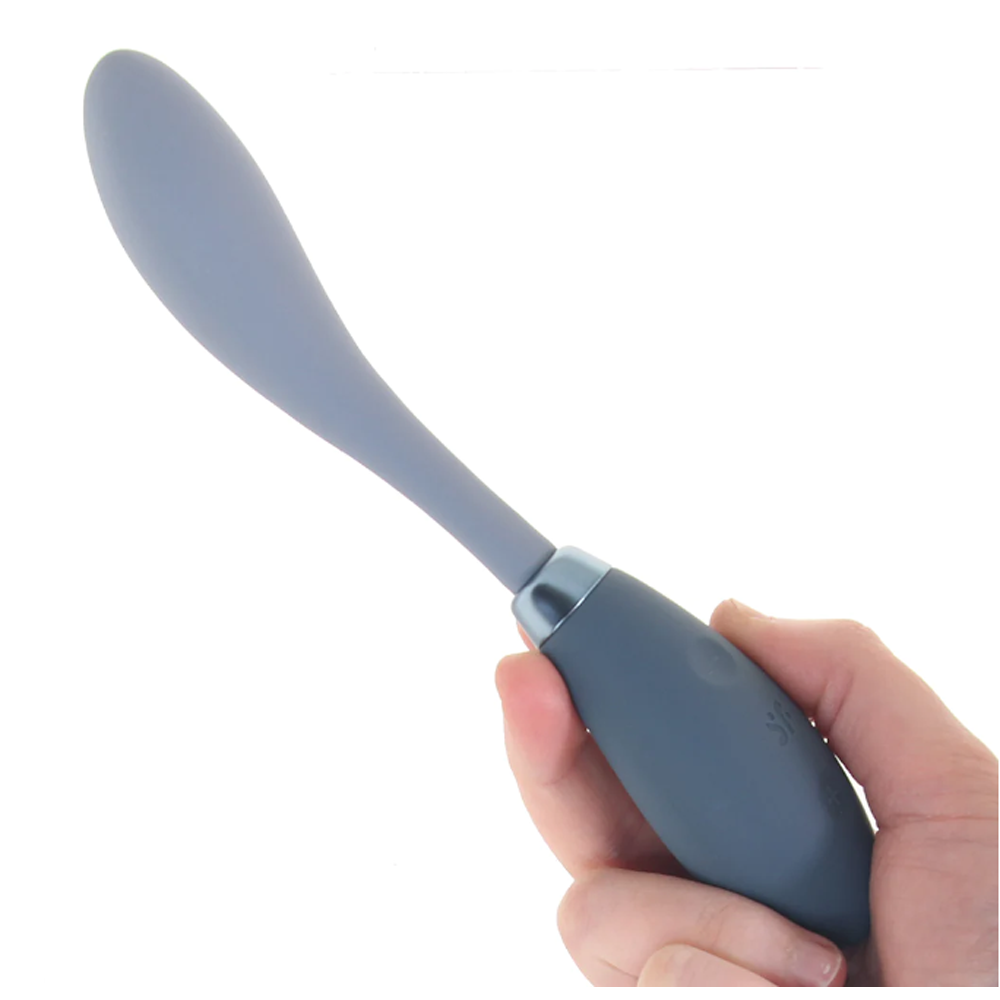 A gray silicone vibrator with a flexible head held in a hand.