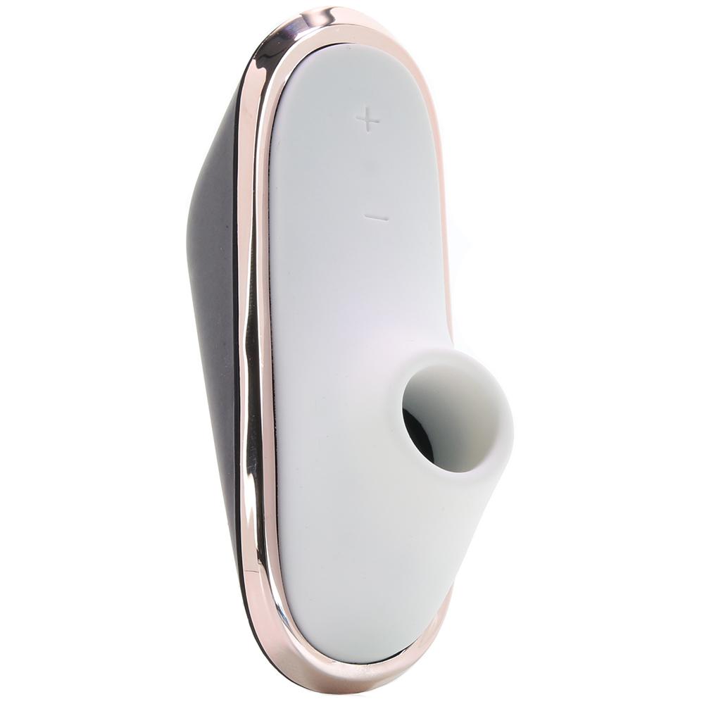 A portable vibrator with a white silicone head and a dark gray body, featuring a rose gold trim.