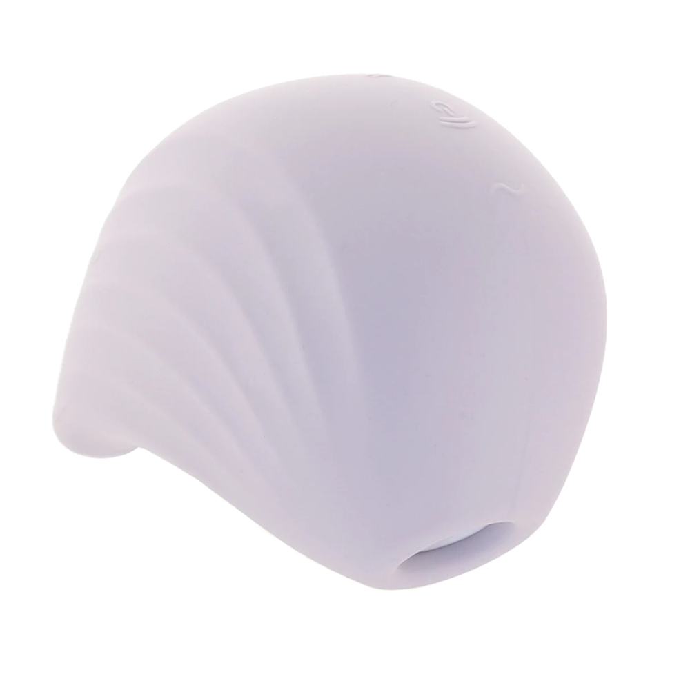 A white, shell-shaped clitoral vibrator with ribbed texture and a small opening.