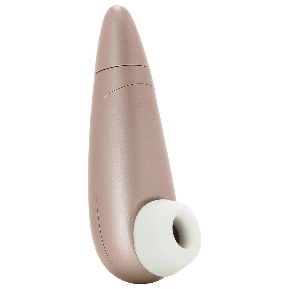 Rosy gold clitoral stimulator with a white silicone tip.