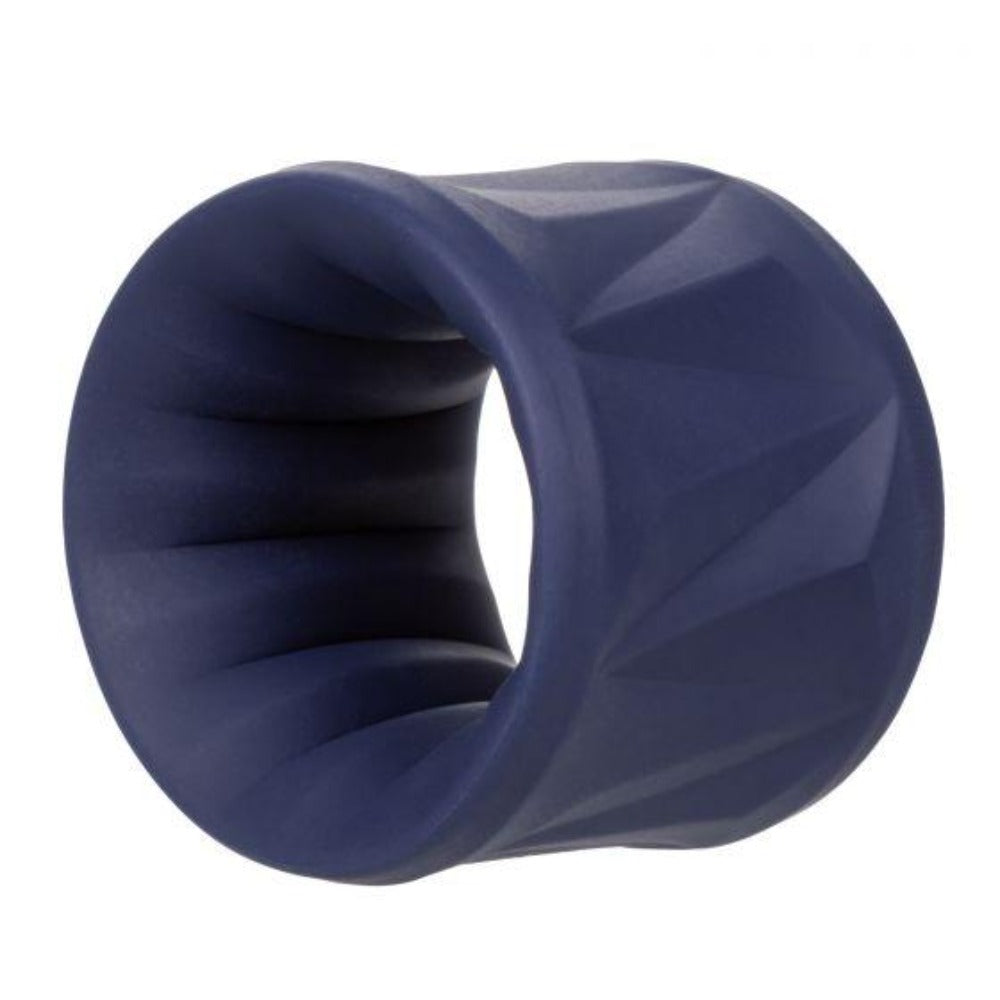 A navy blue silicone cock ring with a ribbed texture on one side and a geometric pattern on the other.
