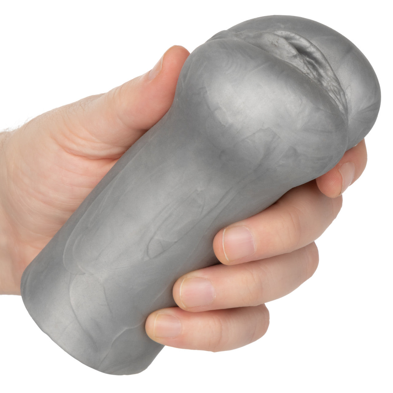 A hand holds a silver, textured suction masturbator.