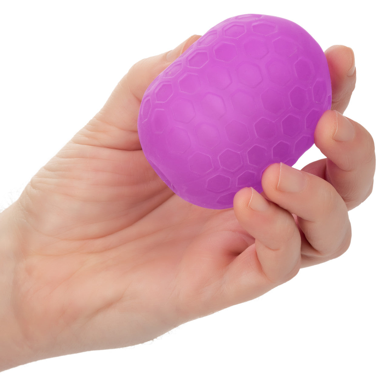 Purple textured reversible stroker held in a hand.