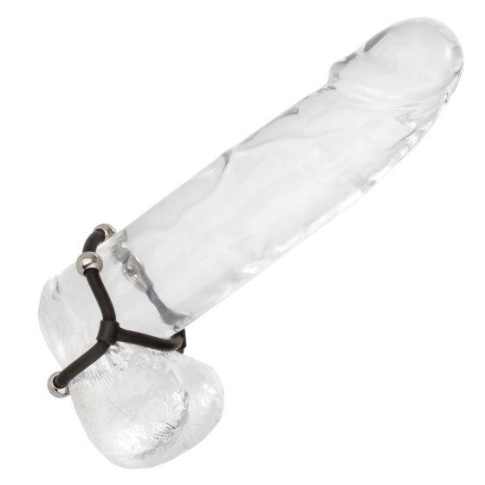 Clear glass cock ring with black straps and steel beads.