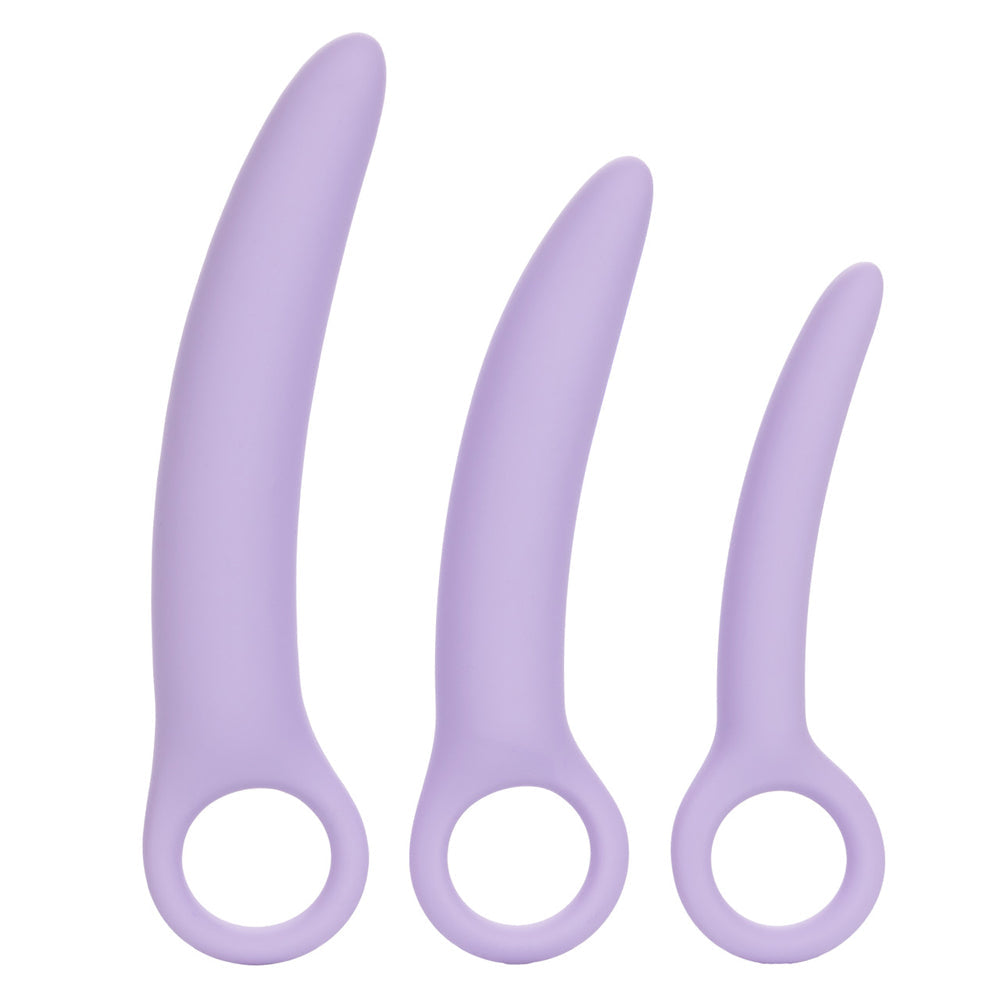 Three curved purple silicone vaginal dilators of varying sizes with finger loops.